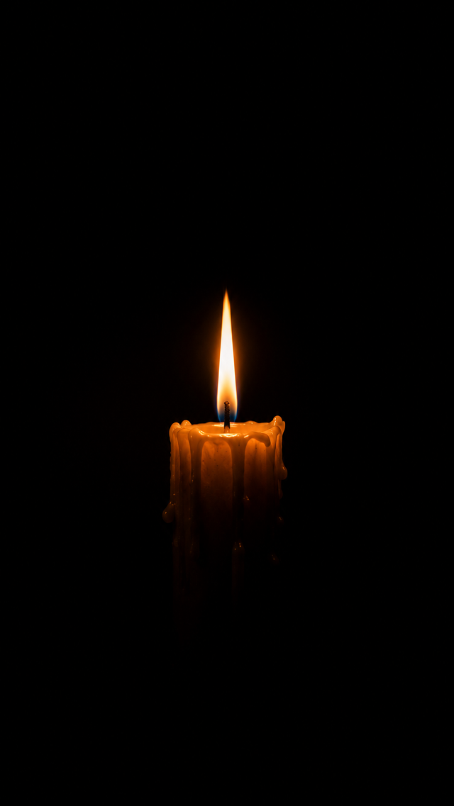Single Candle in Darkness